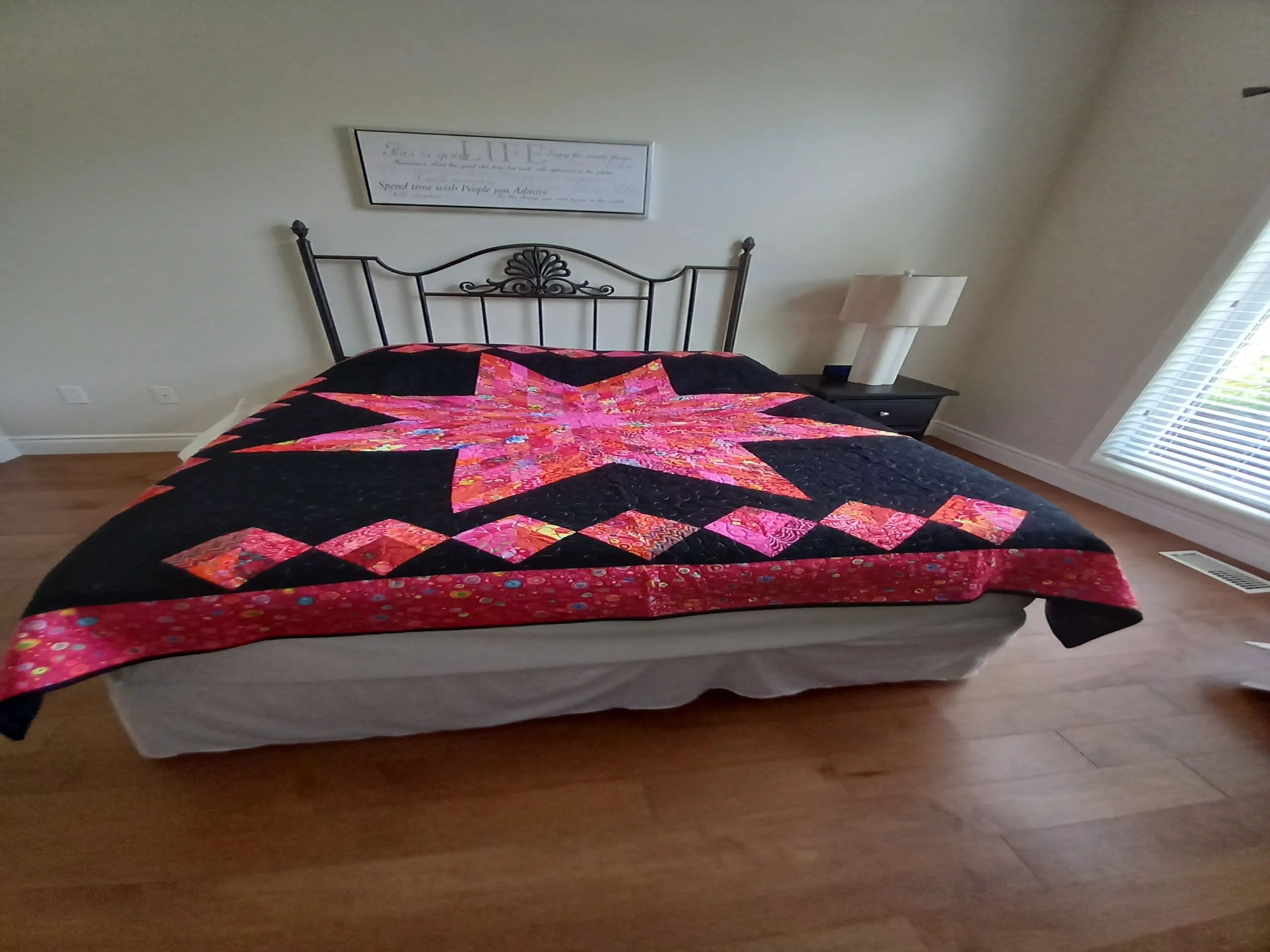 Vintage floral quilt on antique bed