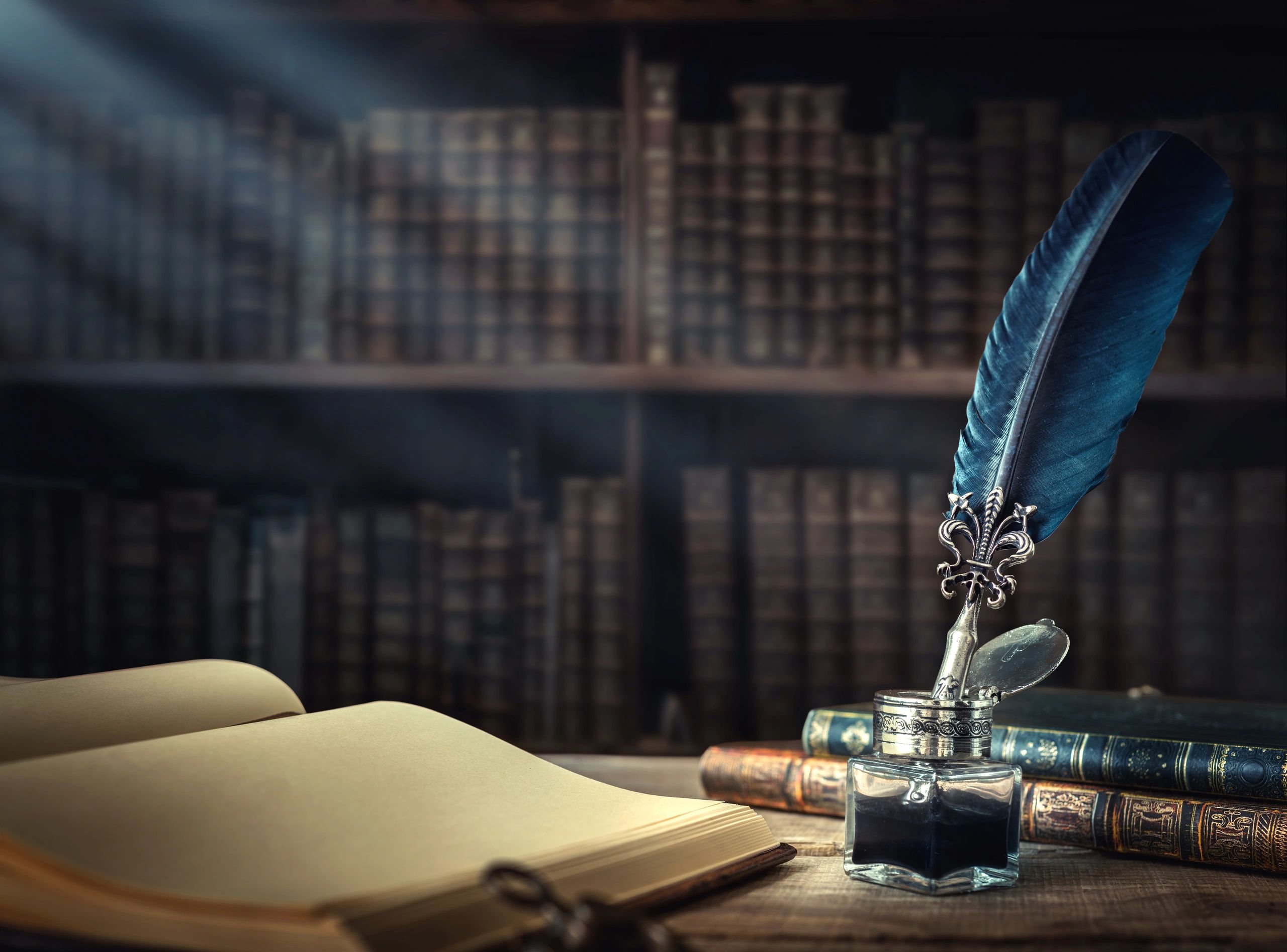 Antique books with quill feather pen and inkwell