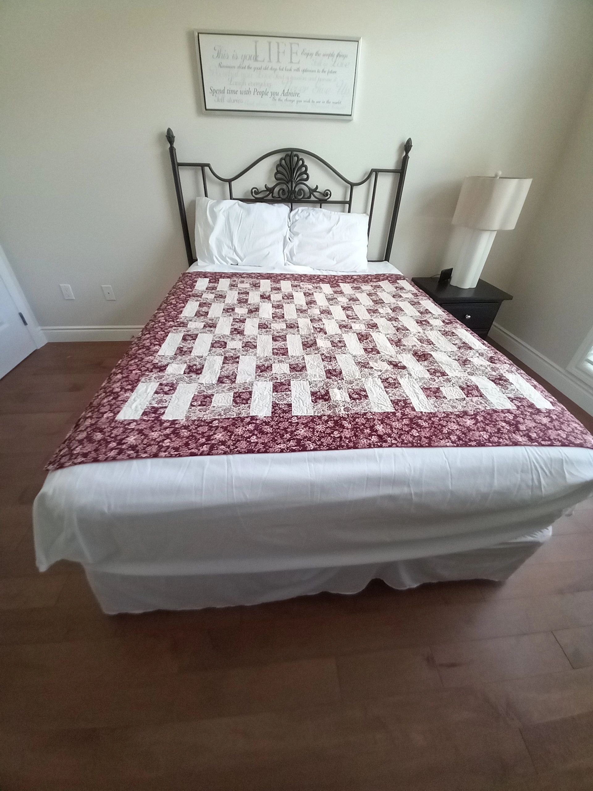 Red checkerboard quilt with floral border